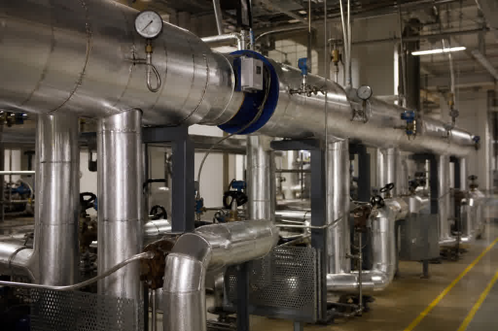 Central industrial steam distribution header in a food manufacturing plant